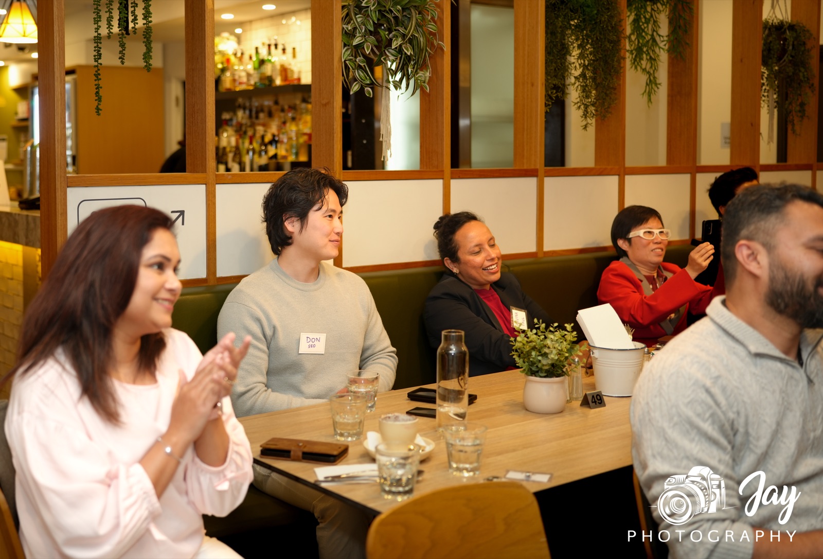 Members seated around the table at a BGN Caulfield dinner, laughing together