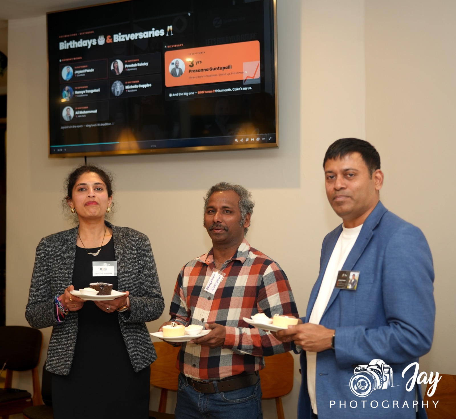BGN Caulfield members holding dessert plates to celebrate birthdays and bizversaries