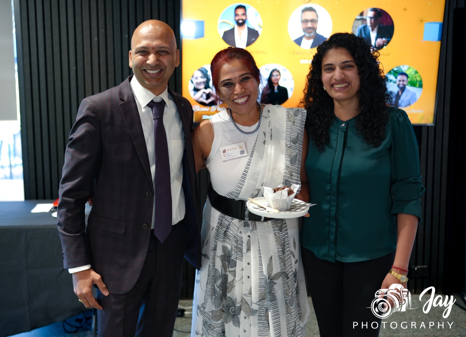 BGN Jells Park members smiling together, one holding a dessert on a plate