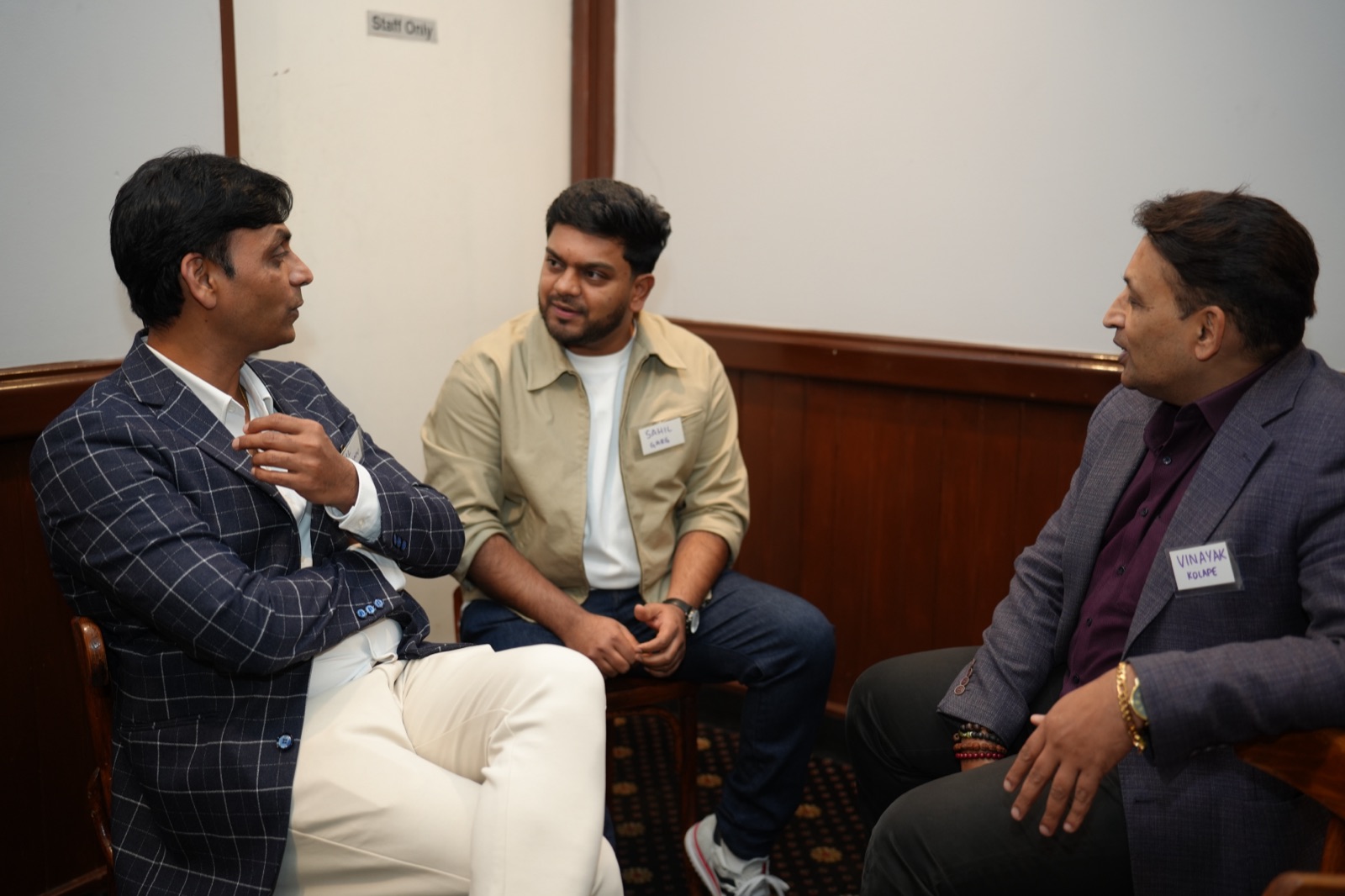 Three BGN members in a close seated conversation