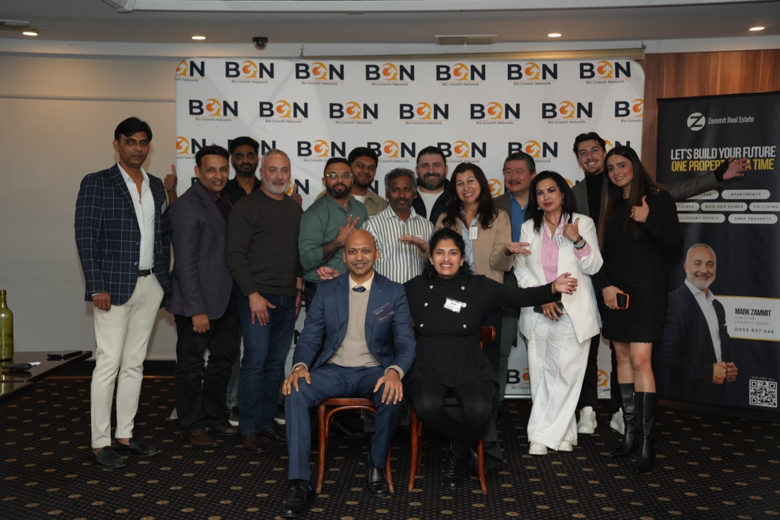 Full BGN group photo at the Williamstown event, everyone gathered at the step-and-repeat banner